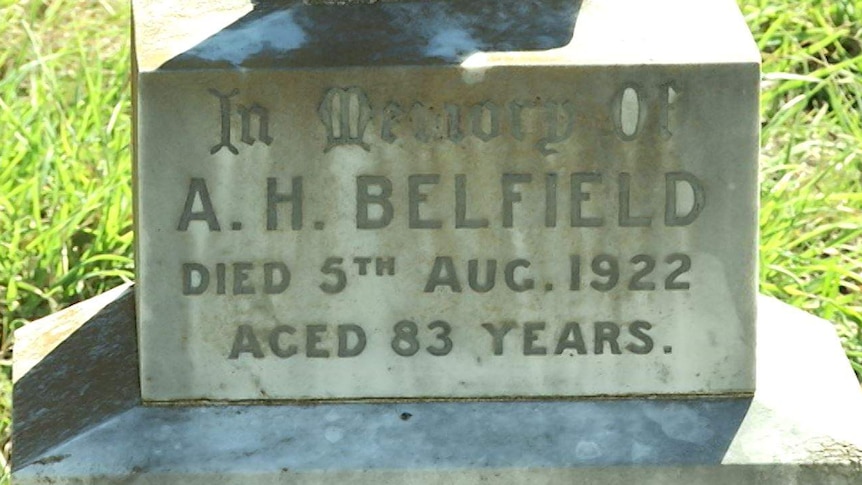 A close-up of a headstone on a gravesite.