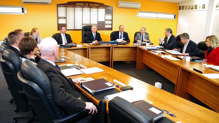 Colin Barnett and Cabinet ministers sitting at desks at the Moora meeting.
