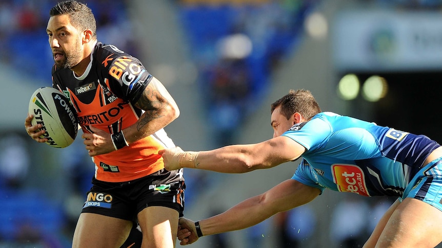 Benji Marshall of the Tigers takes on the Titans