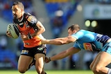 Benji Marshall of the Tigers takes on the Titans