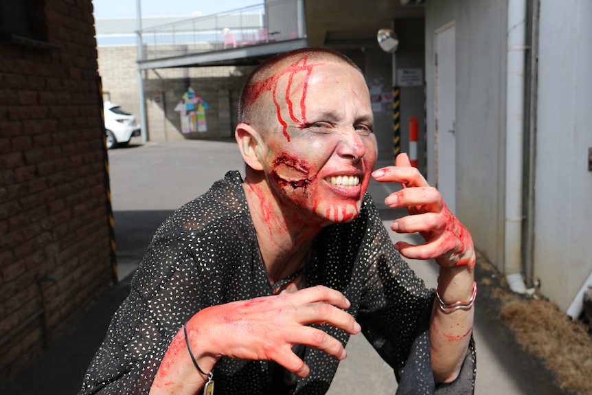 woman growls at camera dressed as zombie