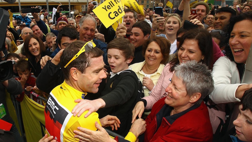 Cadel Evans gets a hug from some of the thousands of fans at Melbourne's Federation Square