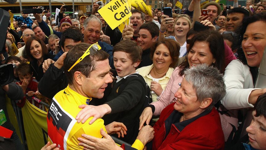 Cadel Evans gets a hug from some of the thousands of fans at Melbourne's Federation Square