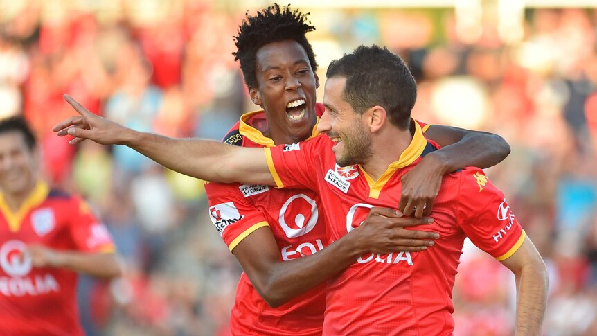 Adelaide United's Sergio Cirio (R) celebrates his goal with Bruce Kamau against Sydney FC.