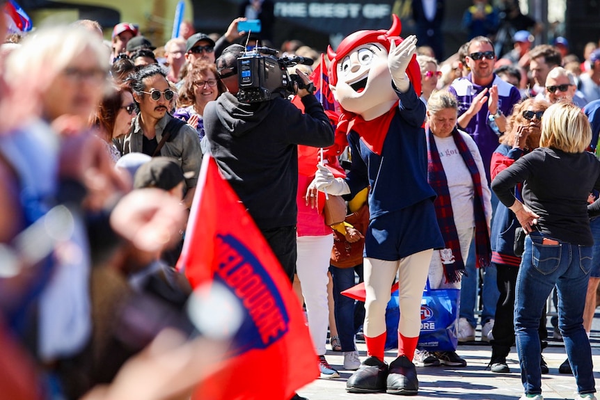 Demons mascot is pictured in front of a television camera