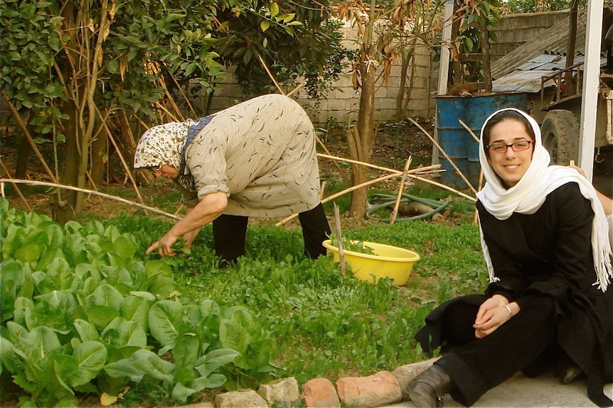 Masih in her home in Iran with her mum in 2009 in the garden.