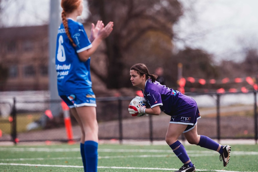 Vara Tyrikos prepares to release the ball after saving a goal.