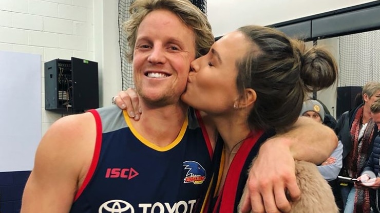 Adelaide Crows player Rory Sloane embraces wife Belinda Sloane.