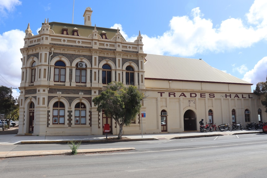 A white heritage building which says TRADES HALL on it.