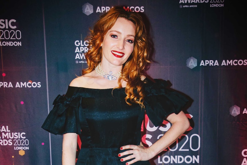Georgia Mooney in dark green dress on the red carpet at the APRA Awards London