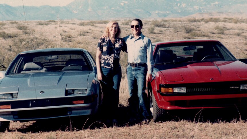 Jerry and Rita Alter pose with their cars.