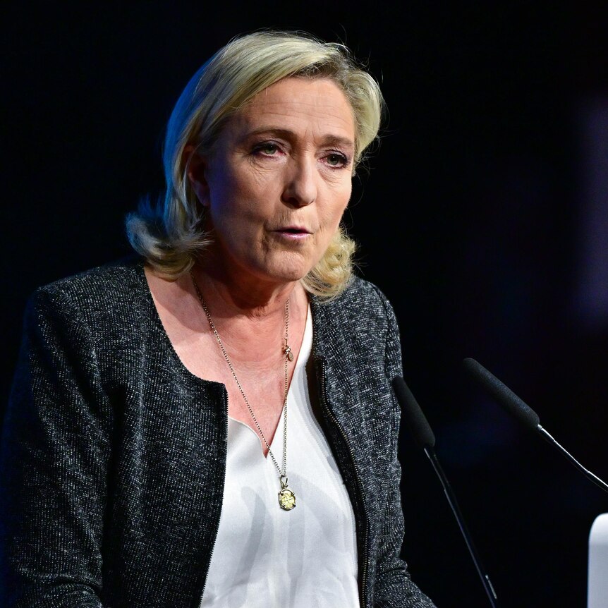 France's far-right politician Marine Le Pen standing at lectern, speaking