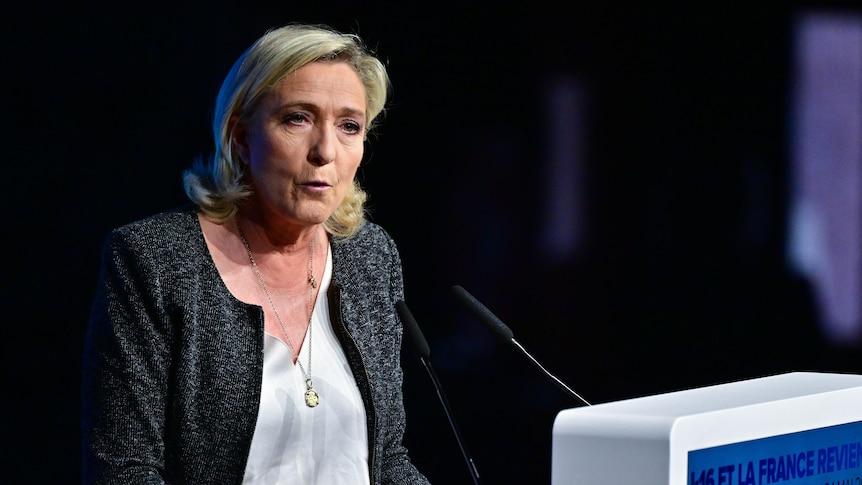 France's far-right politician Marine Le Pen standing at lectern, speaking