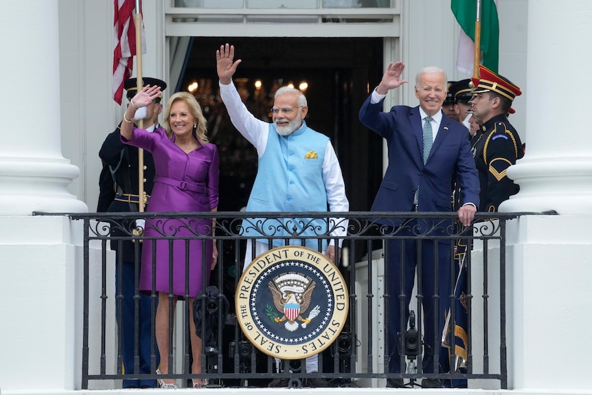 First lady Jill Biden, India's Prime Minister Narendra Modi and President Joe Biden wave from the White House balcony.