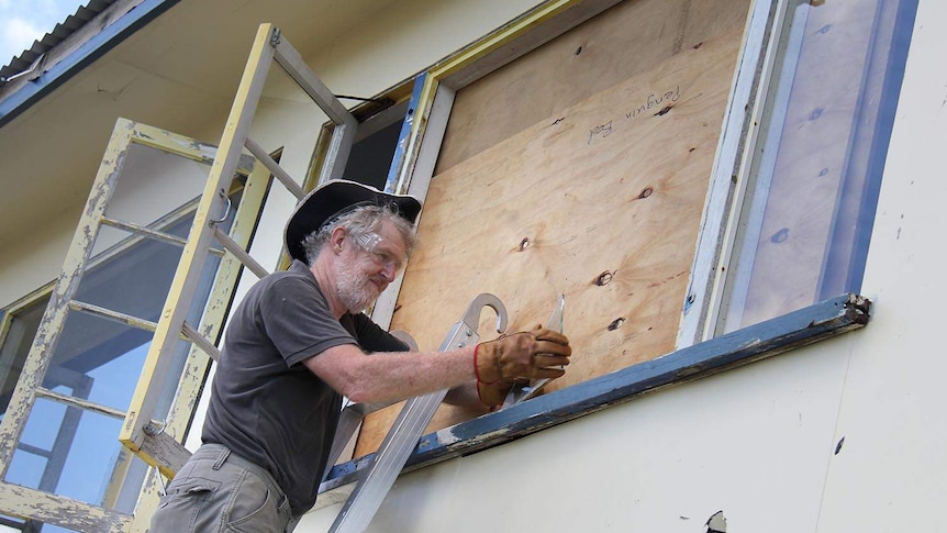 Yeppoon resident Mick Barker repairs a broken window