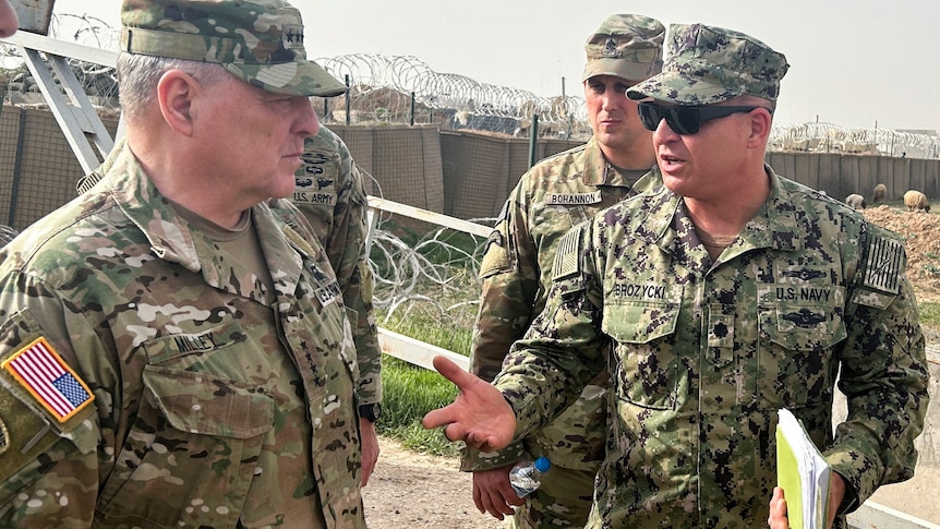 US army general Mark Milley speaks with US forces personnel in uniform in Syria