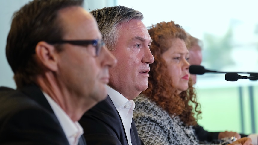 Mark Anderson, Eddie McGuire and Jodie Sizer sit in a line, speaking at a press conference