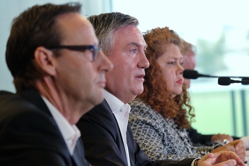 Mark Anderson, Eddie McGuire and Jodie Sizer sit in a line, speaking at a press conference