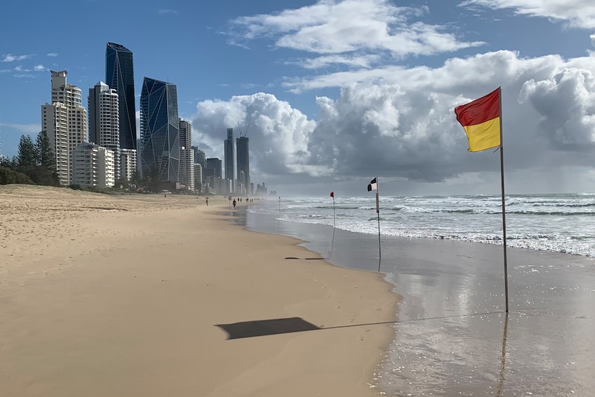 Beaches on the gold coast against buildings with surflifesaving flags