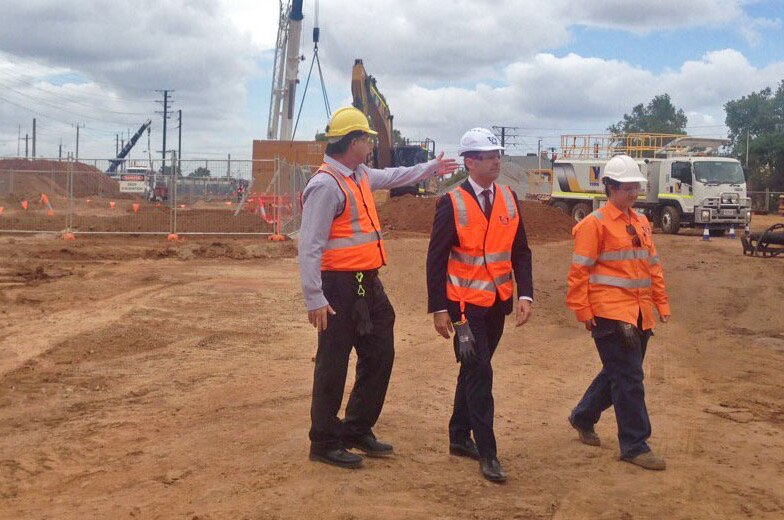Stephen Mullighan in hard hat with construction officials