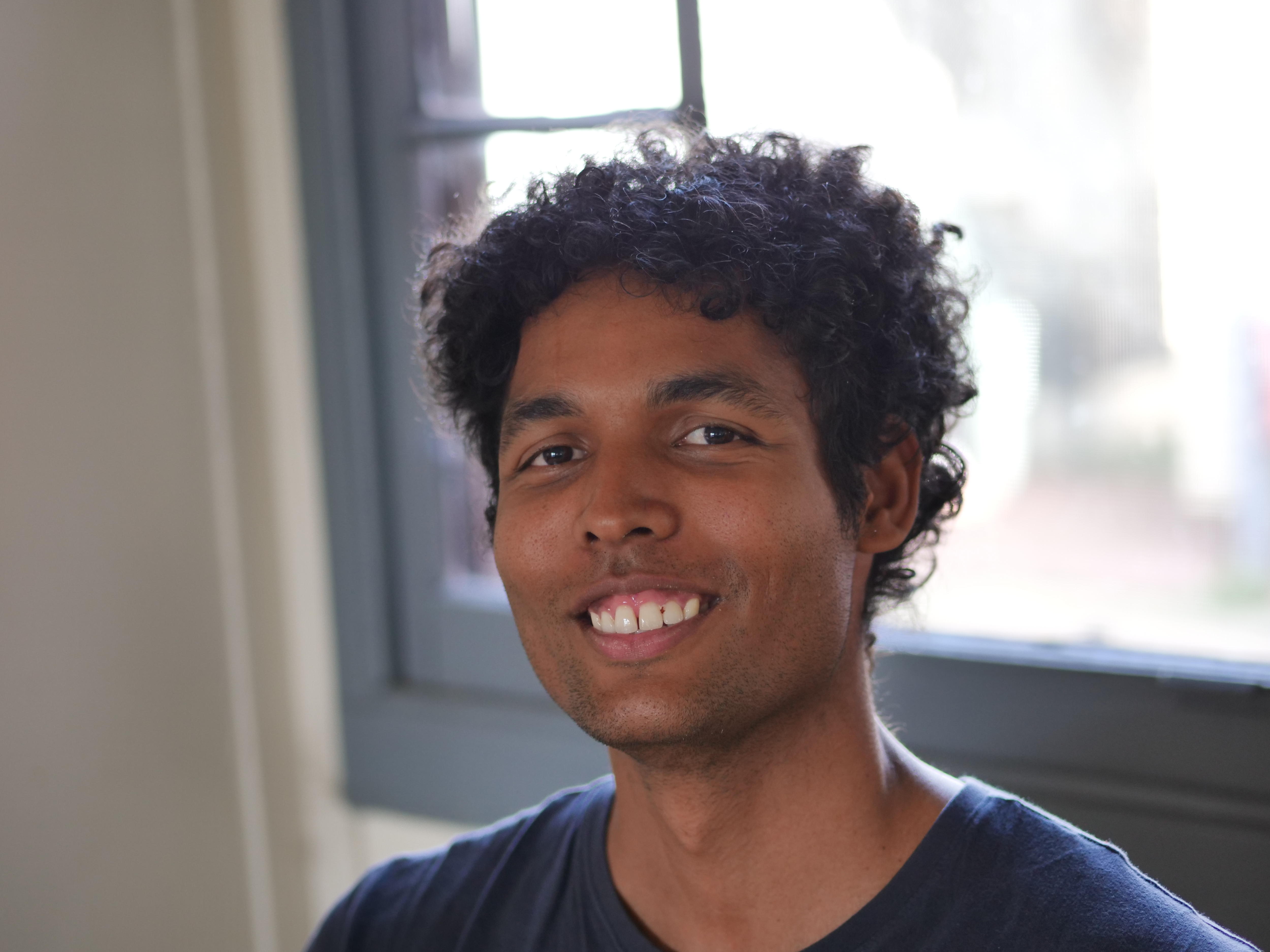 A backpacker looks at the camera