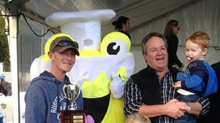Kevin Sharp, with his son and grandchildren, holding the trophy for the best professional vanilla slice at this year's event.