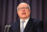 George Brandis speaks to reporters in Canberra