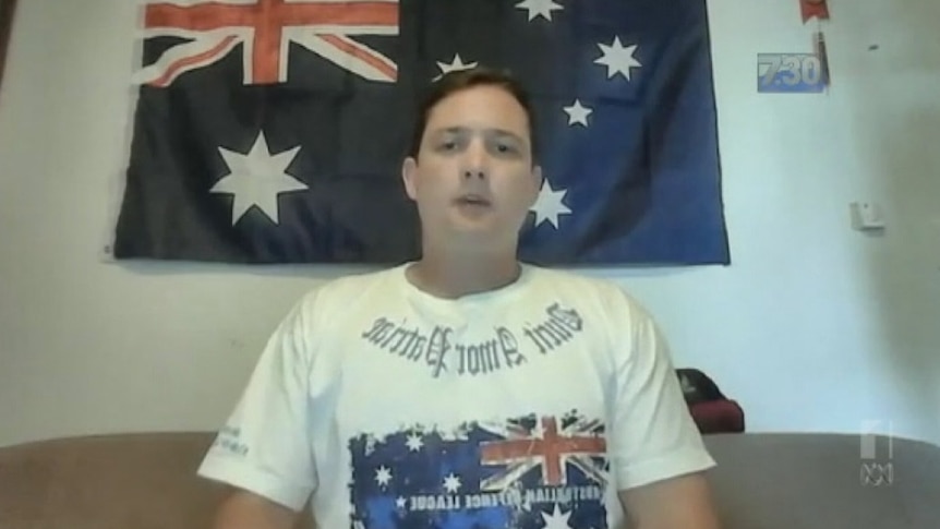 Ralph Cerminara in front of an Australian flag