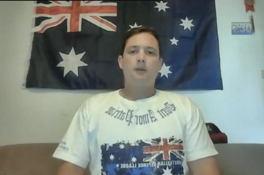 Ralph Cerminara in front of an Australian flag