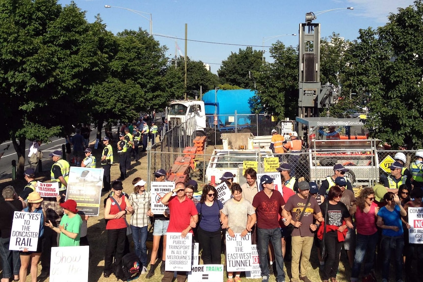 East West Link protesters circle drill site with police standing nearby