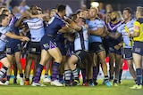 Nelson Asofa-Solomona of the Storm and Paul Gallen of the Sharks square off at the end of the game.
