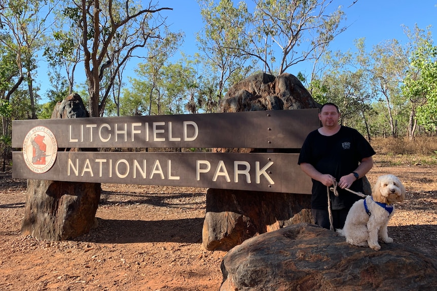 Man and dog near litchfield national park sign