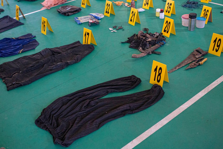 Evidence items which belonged to suspected militants on the floor