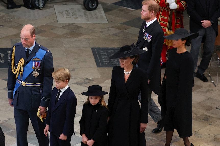 Prince William, George, Charlotte, Kate, Harry and Meghan walk through a church 