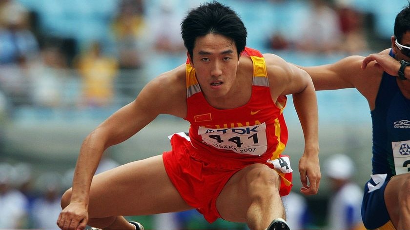 Xiang Liu clears a hurdle