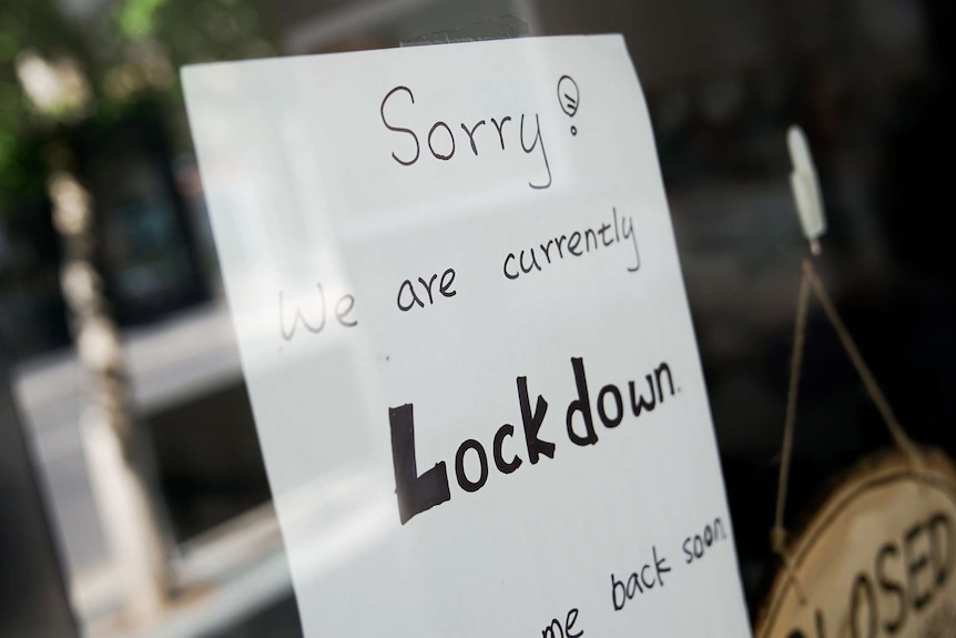 A sign on a shop front that reads: "Sorry, we are currently in lockdown".