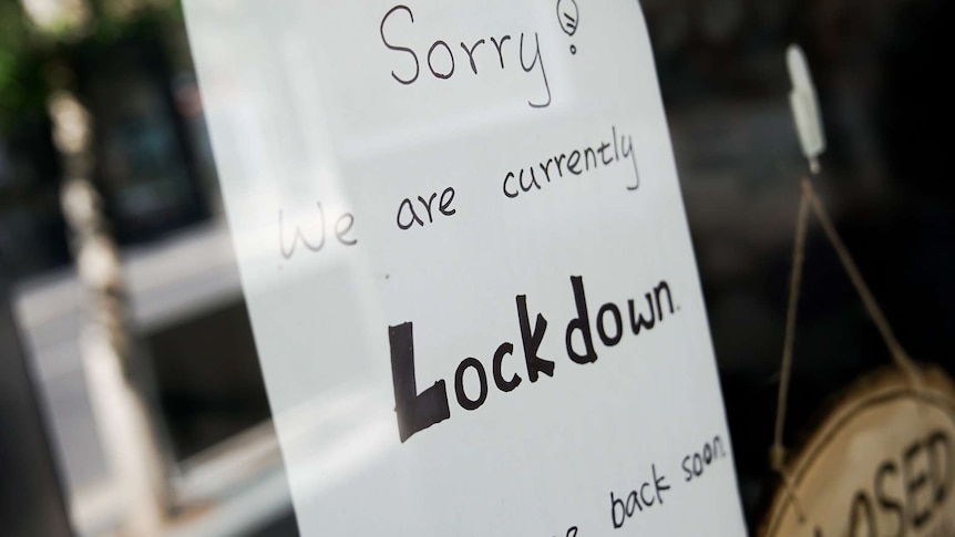 A sign on a shop front that reads: "Sorry, we are currently in lockdown".