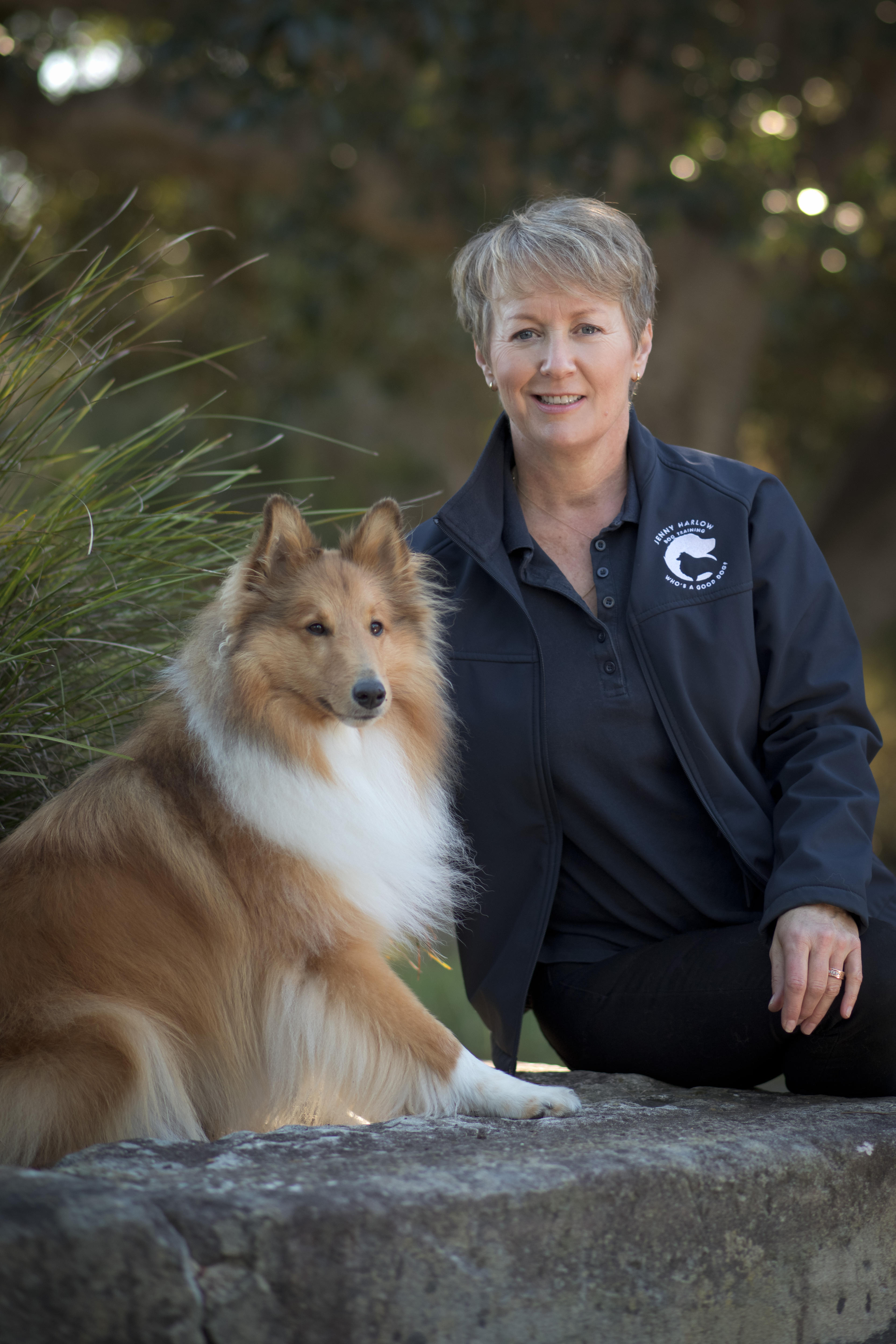 Jenny Harlow, a middle-aged woman with short hair, with one of her dogs — a small collie.