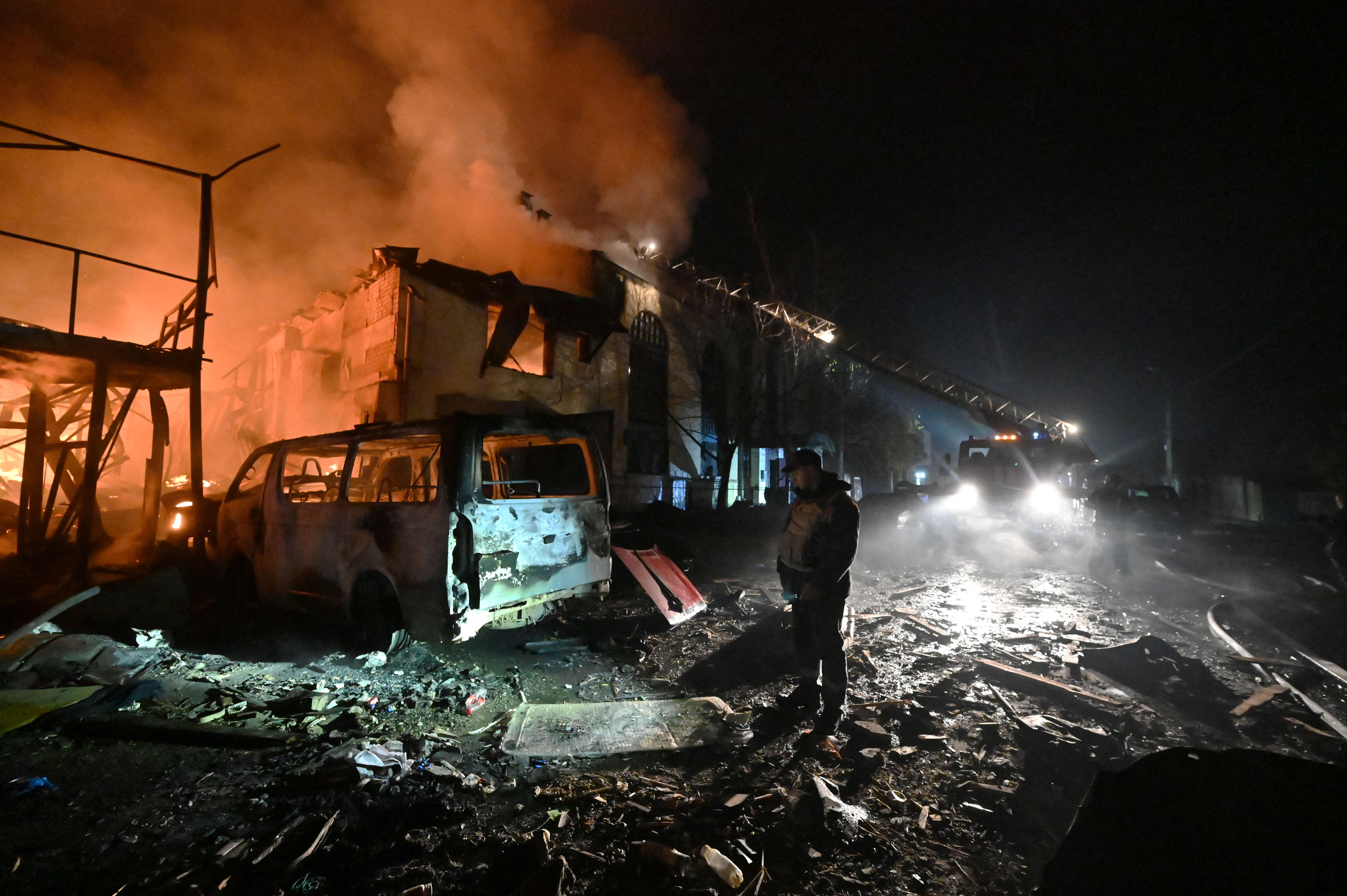 Man looks down at scorched car 