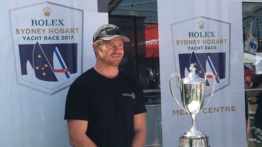 InfoTrack skipper Tom Slingsby with the Line Honours trophy.