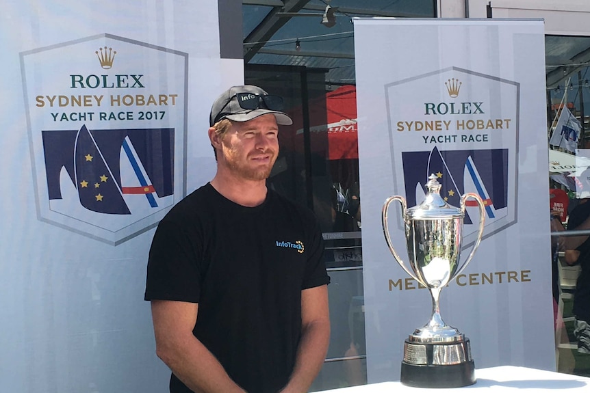 InfoTrack skipper Tom Slingsby with the Line Honours trophy.