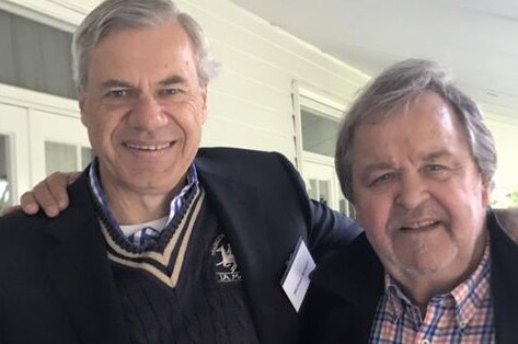 Liberal Party president Michael Kroger (left) and Barrie Macmillan stand with their arms around each other.