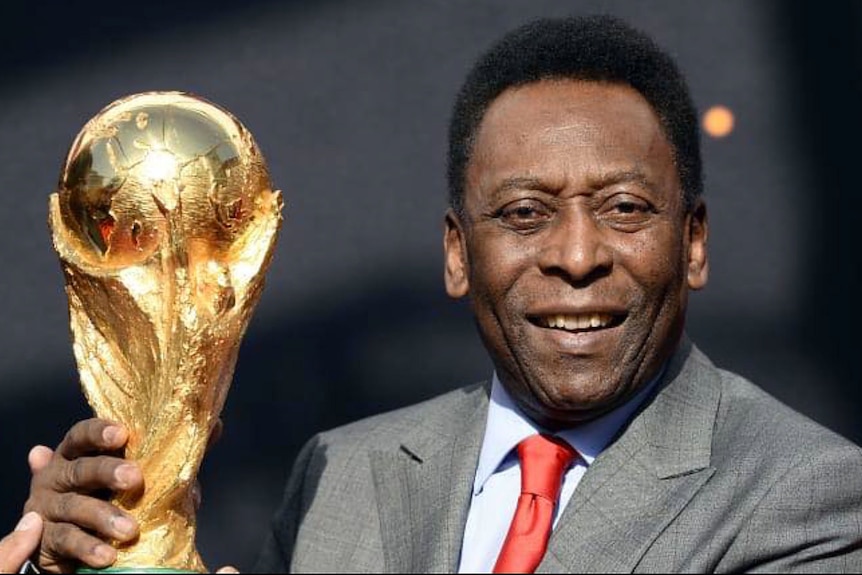 Pele holds the world cup trophy