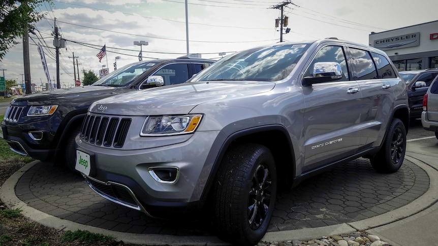The 2015 Jeep Grand Cherokee on display outside a car dealership