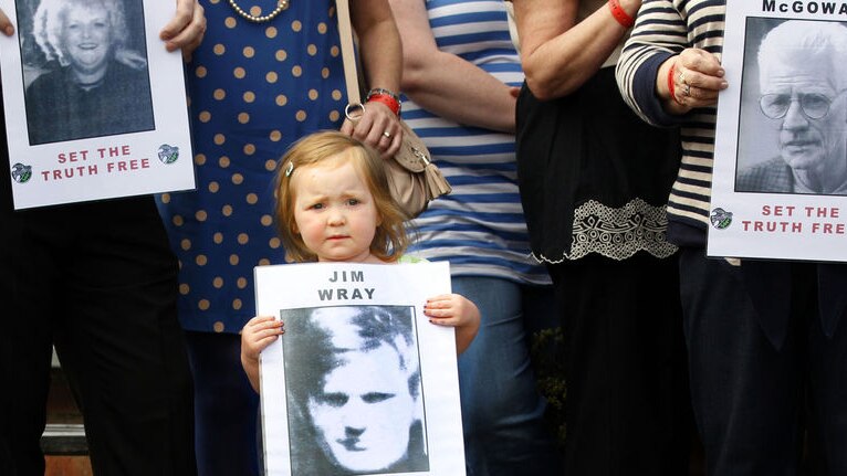 A young girl holds a picture of one of those killed in the Bloody Sunday shootings.