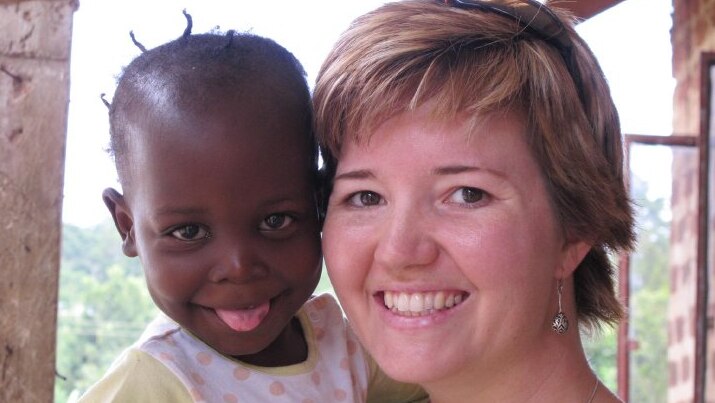Griffith University law lecturer Kate Van Doore with rescued Ugandan child.