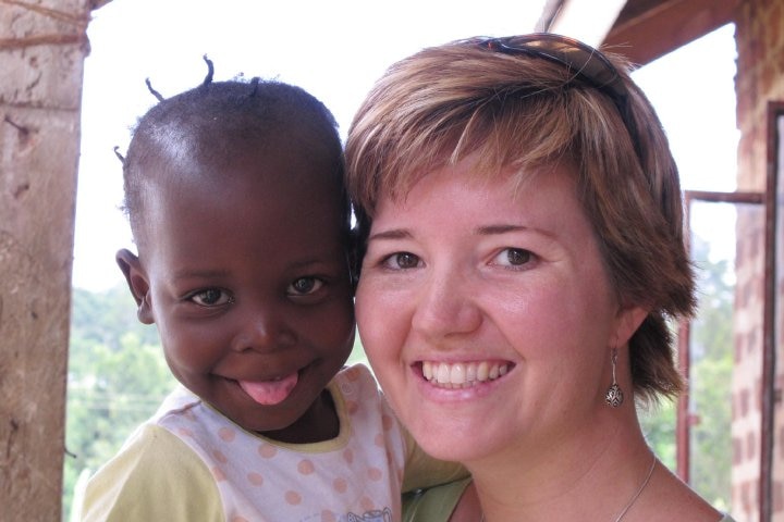 Griffith University law lecturer Kate Van Doore with rescued Ugandan child.