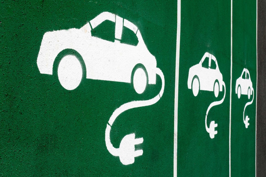 A green background with white spray-painted electric cars.
