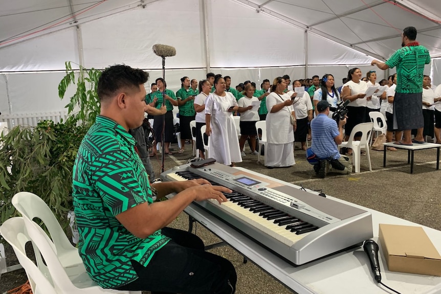 Photo of a man playing the keyboard.