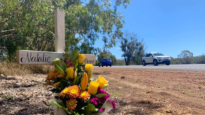 Flowers placed on the side of a rural highway